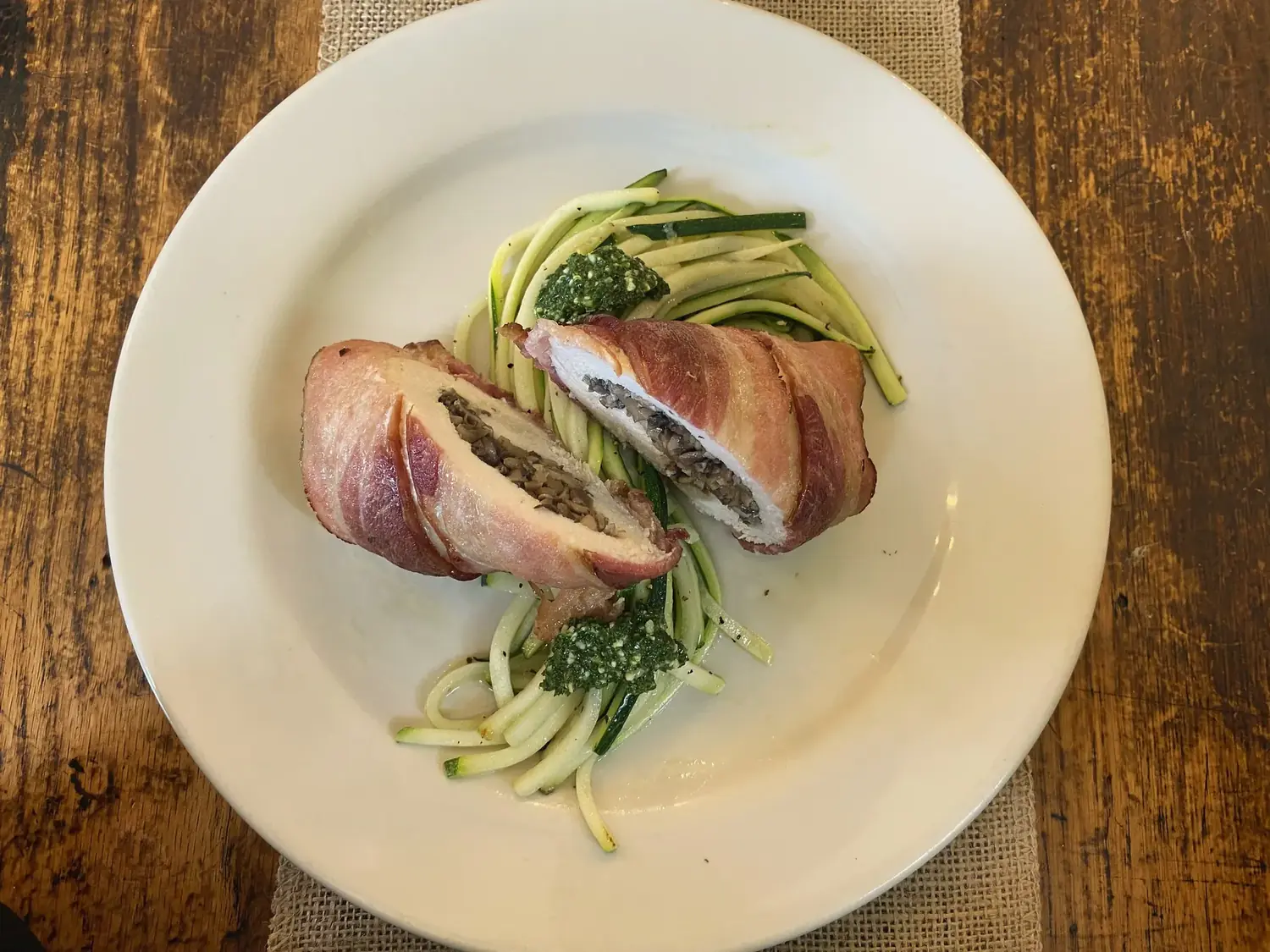 Prosciutto-wrapped stuffed chicken on zucchini noodles with pesto — chef-prepared meal at The Old Ruth
