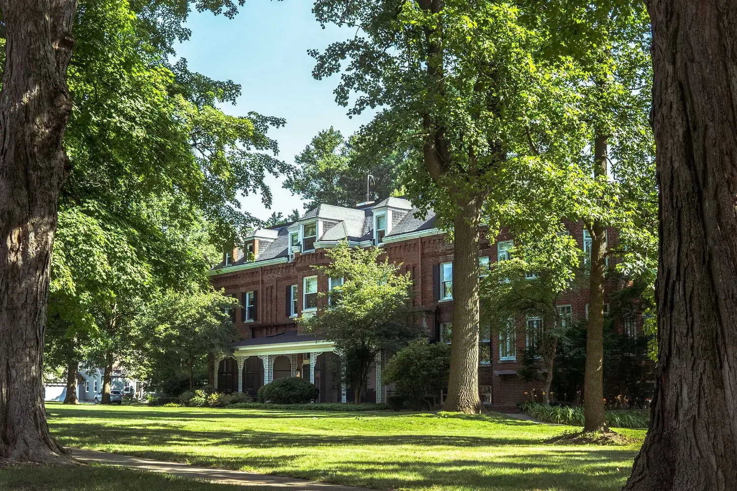 The Old Ruth Estate — a 30,000 sq. ft. historic mansion in La Porte, Indiana, seen across its lawn through mature trees